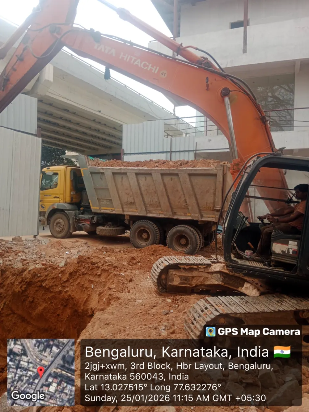 Tata Hitachi excavator on active demolition site, Bengaluru